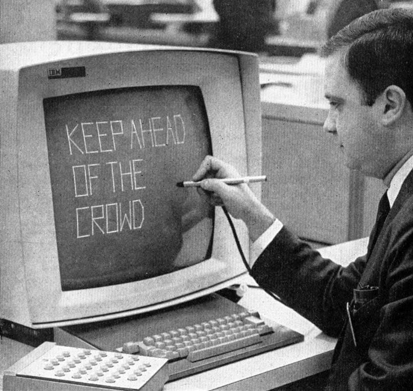 man writing the words keep ahead of the crowd with pen on IBM computer screen from 1964